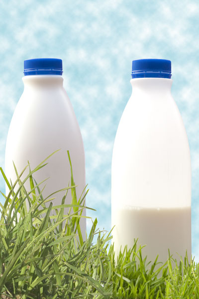 Composite photo of two milk bottle photos and two grass photos.